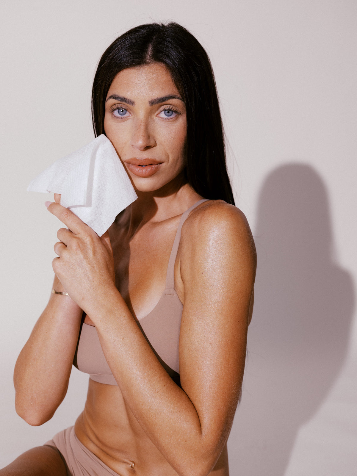 Model holding a Face Cloths towel to her cheek
