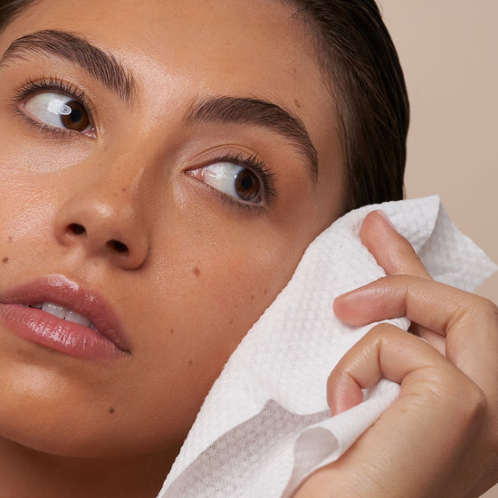 lifestyle 1 box, a woman drying her face with a single-use face cloth