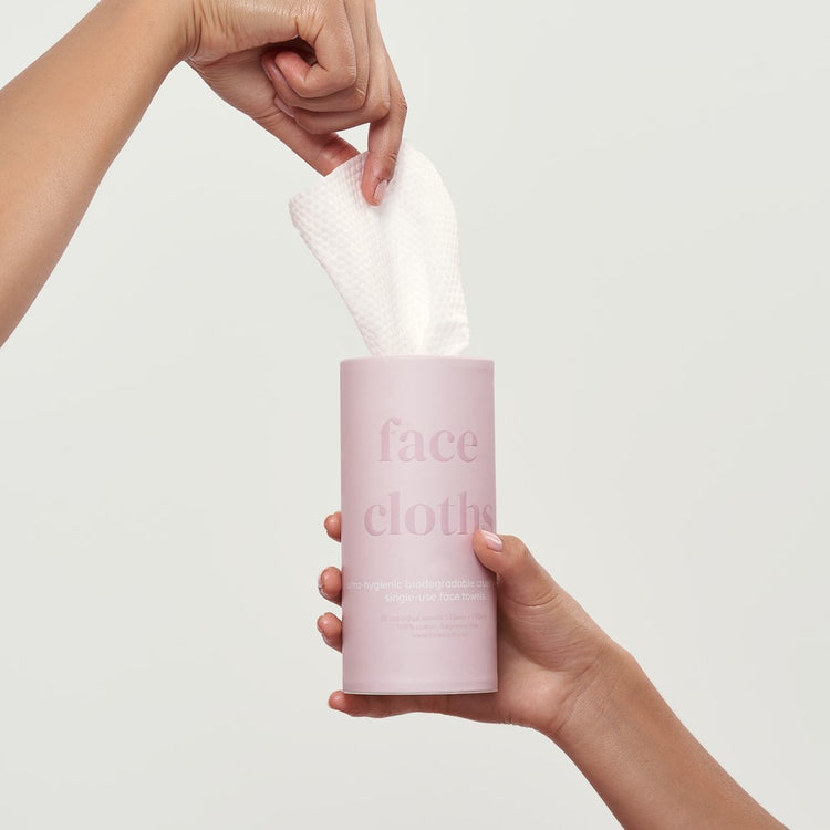 strip, a hand pulling a face cloth from the tube