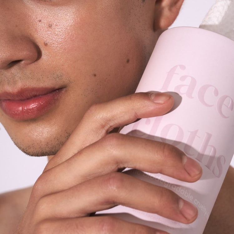 strip, holding a tube of face cloths against clean skin